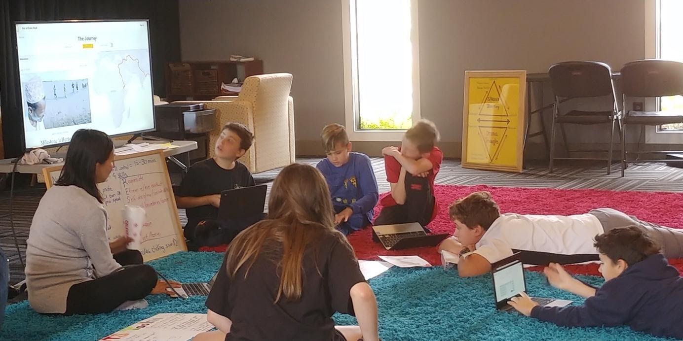 A group of people sitting in a room

Description automatically generated